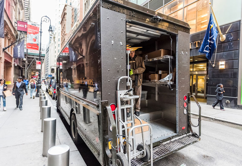 UPS, United Parcel Service, man unloading packages delivery in NYC Manhattan